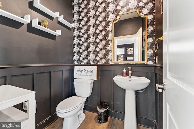 4495 Shakespeare Cir, White Plains, MD 20695 - bathroom featuring wallpapered walls, wood finished floors, wainscoting, and a decorative wall