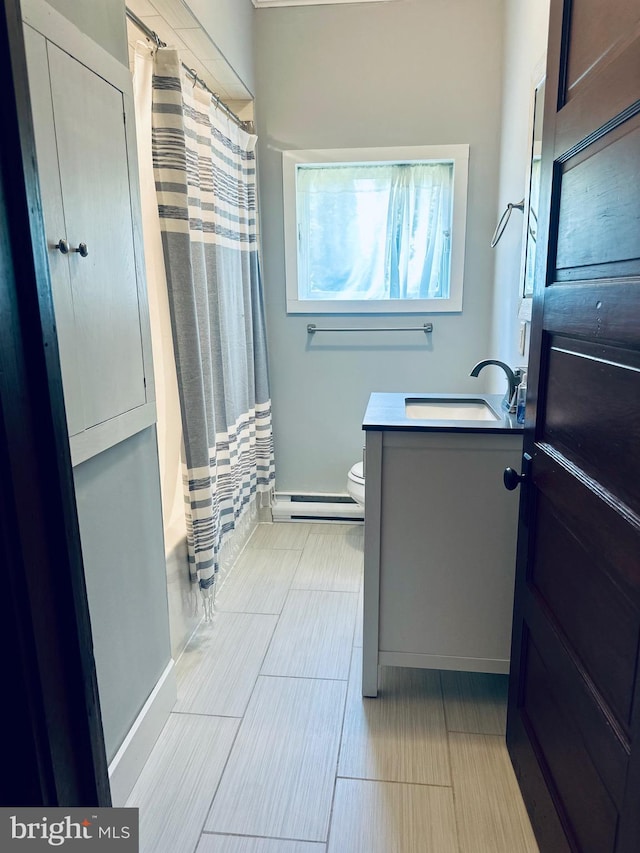 531 S 3rd St, Oakland, MD 21550 - full bath with baseboard heating, vanity, toilet, shower / bath combination with curtain, and wood tiled floors