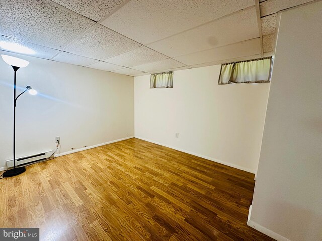 531 S 3rd St, Oakland, MD 21550 - finished basement with a baseboard radiator, wood finished floors, baseboards, and a drop ceiling