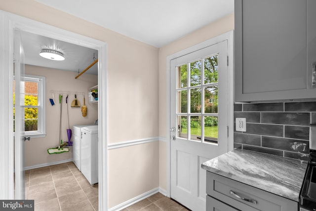 9824 Whetstone Dr, Montgomery Village, MD 20886 - doorway with washing machine and dryer, plenty of natural light, baseboards, and light tile patterned floors