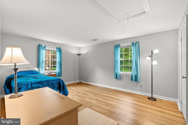 9824 Whetstone Dr, Montgomery Village, MD 20886 - bedroom with attic access, multiple windows, wood finished floors, and baseboards
