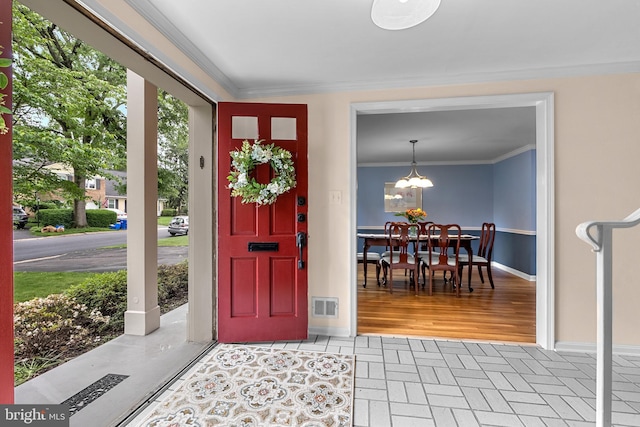 9824 Whetstone Dr, Montgomery Village, MD 20886 - entryway with ornamental molding, baseboards, a chandelier, and brick patterned floors