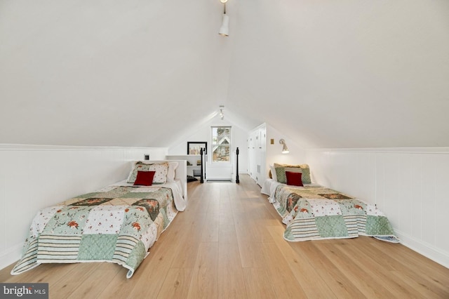 12 Sergeant St, Princeton, NJ 08540 - bedroom with wood finished floors, lofted ceiling, and a decorative wall