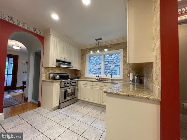 12 Sergeant St, Princeton, NJ 08540 - kitchen with stainless steel gas stove, under cabinet range hood, a sink, backsplash, and recessed lighting