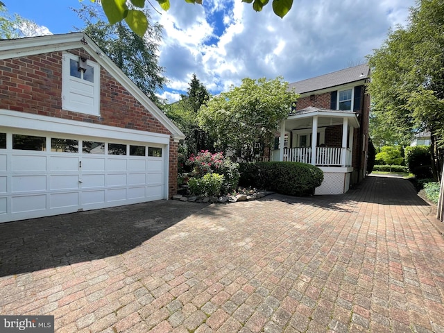 12 Sergeant St, Princeton, NJ 08540 - view of side of property featuring brick siding, covered porch, and a garage