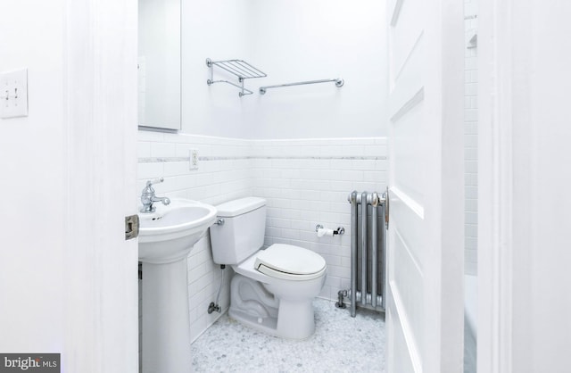 1432 C St SE, Washington, DC 20003 - bathroom with radiator, wainscoting, tile walls, and a shower