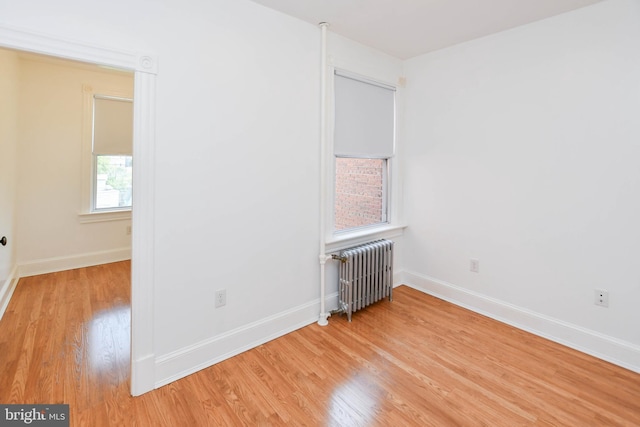 1432 C St SE, Washington, DC 20003 - unfurnished room with radiator heating unit and light wood-style floors