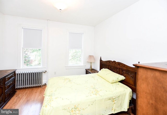 1432 C St SE, Washington, DC 20003 - bedroom featuring radiator and light wood-style flooring