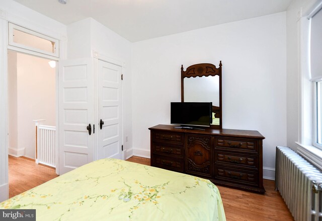 1432 C St SE, Washington, DC 20003 - bedroom with radiator heating unit and wood finished floors