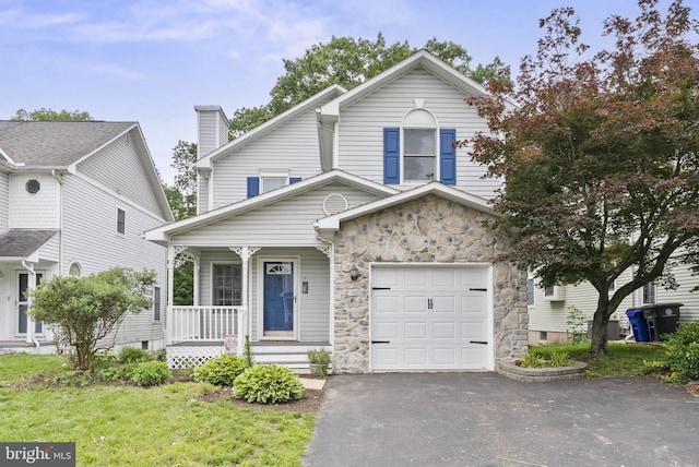 583 Upland St, Pottstown, PA 19464 - view of front of house featuring a porch, driveway, a garage, and stone siding