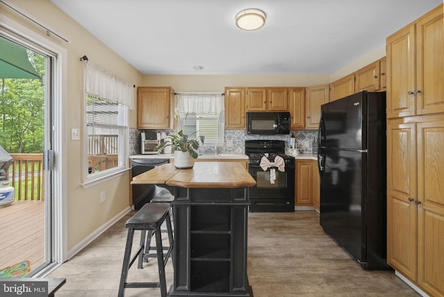583 Upland St, Pottstown, PA 19464 - kitchen featuring black appliances, tasteful backsplash, a kitchen island, and butcher block counters