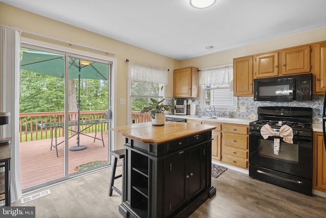 583 Upland St, Pottstown, PA 19464 - kitchen with black appliances, a sink, light wood-style flooring, and dark cabinetry