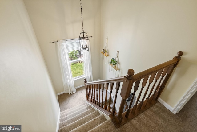 583 Upland St, Pottstown, PA 19464 - staircase featuring carpet floors, baseboards, and a chandelier