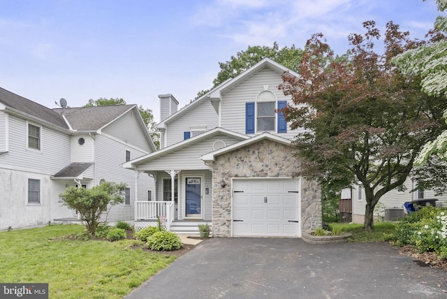 583 Upland St, Pottstown, PA 19464 - view of front of property featuring a porch, stone siding, driveway, a front yard, and central AC