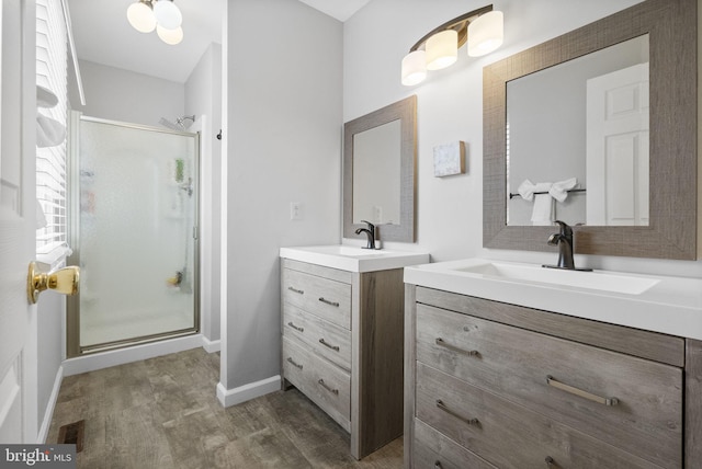 583 Upland St, Pottstown, PA 19464 - bathroom with a shower stall, wood finished floors, two vanities, and baseboards