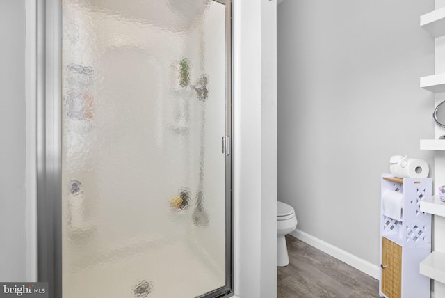 583 Upland St, Pottstown, PA 19464 - bathroom featuring wood finished floors, a shower stall, toilet, and baseboards