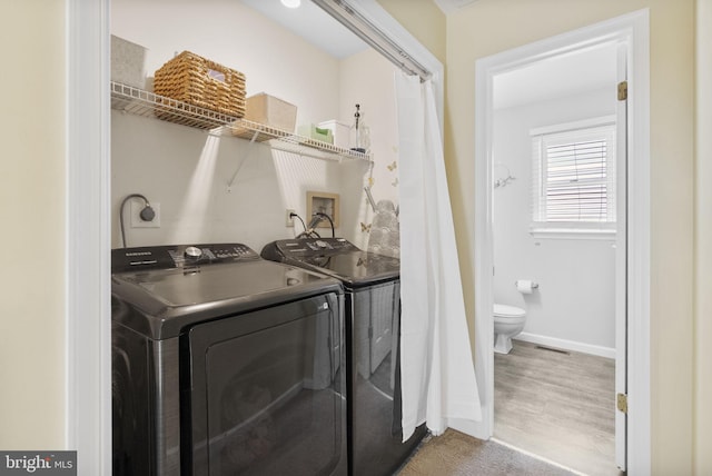 583 Upland St, Pottstown, PA 19464 - washroom with washer and clothes dryer, wood finished floors, and baseboards