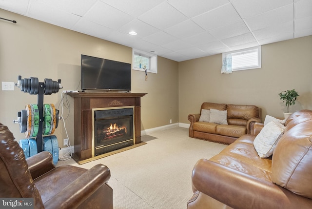 583 Upland St, Pottstown, PA 19464 - carpeted living room featuring baseboards, a fireplace with flush hearth, and a drop ceiling