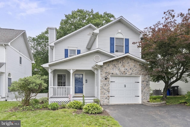 583 Upland St, Pottstown, PA 19464 - view of front of home with covered porch, cooling unit, stone siding, driveway, and an attached garage