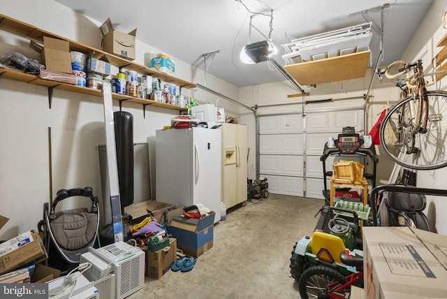 583 Upland St, Pottstown, PA 19464 - garage featuring freestanding refrigerator, a garage door opener, and white refrigerator with ice dispenser