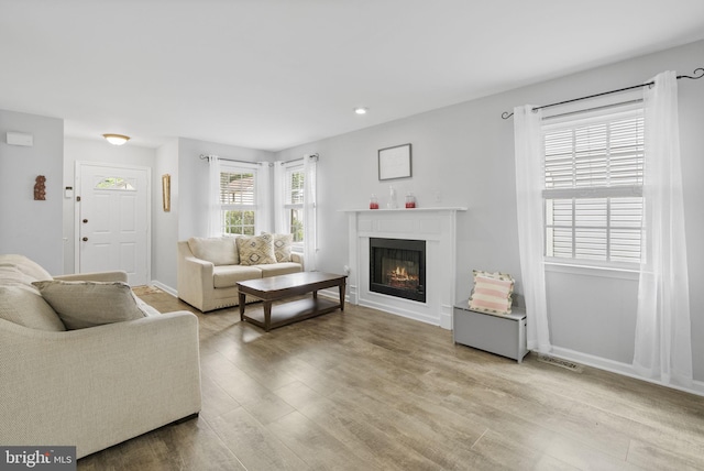 583 Upland St, Pottstown, PA 19464 - living room featuring light wood-style floors, a glass covered fireplace, baseboards, and recessed lighting