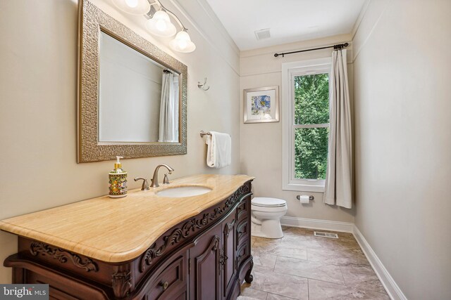 12213 Lake Potomac Ter, Potomac, MD 20854 - bathroom with toilet, vanity, and baseboards