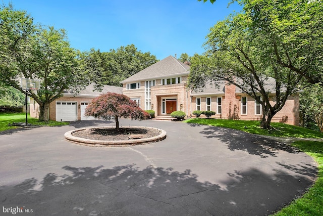 12213 Lake Potomac Ter, Potomac, MD 20854 - colonial inspired home with curved driveway, brick siding, and a garage