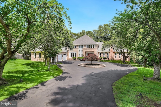 12213 Lake Potomac Ter, Potomac, MD 20854 - colonial home featuring curved driveway, an attached garage, and a front yard
