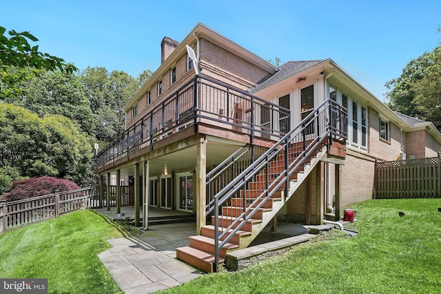 12213 Lake Potomac Ter, Potomac, MD 20854 - back of house featuring a patio area, a wooden deck, a chimney, stairs, and brick siding
