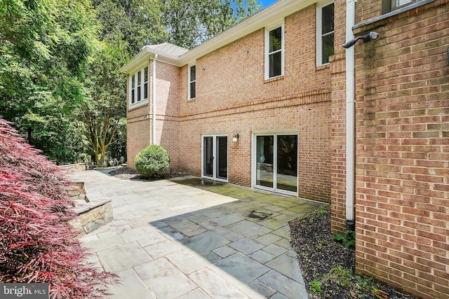 12213 Lake Potomac Ter, Potomac, MD 20854 - back of property featuring brick siding and a patio area