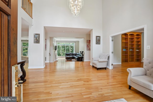12213 Lake Potomac Ter, Potomac, MD 20854 - entrance foyer featuring a high ceiling, light wood-type flooring, a chandelier, and baseboards