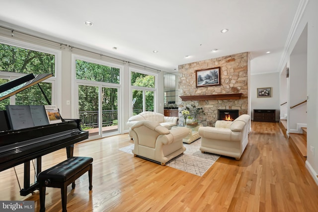 12213 Lake Potomac Ter, Potomac, MD 20854 - living room featuring plenty of natural light, crown molding, stairs, wood finished floors, and a fireplace