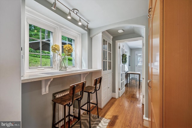 122 Waverly Rd, Wyncote, PA 19095 - hall featuring light wood-style floors, arched walkways, healthy amount of natural light, and baseboards