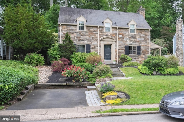 122 Waverly Rd, Wyncote, PA 19095 - view of front of house featuring a chimney, stone siding, and a front yard