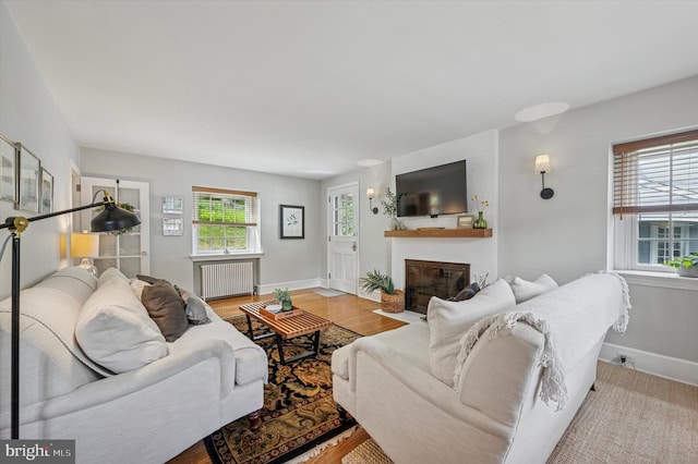 122 Waverly Rd, Wyncote, PA 19095 - living room featuring radiator heating unit, a fireplace with flush hearth, baseboards, and wood finished floors