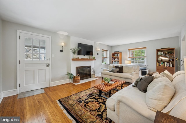 122 Waverly Rd, Wyncote, PA 19095 - living area with a fireplace with flush hearth, light wood-type flooring, and baseboards