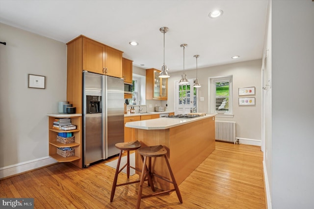 122 Waverly Rd, Wyncote, PA 19095 - kitchen featuring appliances with stainless steel finishes, radiator heating unit, light wood-style flooring, baseboards, and light countertops