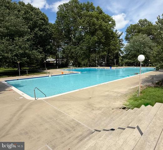 13423 Rippling Brook Dr, Silver Spring, MD 20906 - community pool featuring view of scattered trees and a patio
