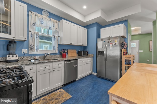 5012 Catalpha Rd, Baltimore, MD 21214 - kitchen with appliances with stainless steel finishes, white cabinetry, glass insert cabinets, light stone counters, and recessed lighting