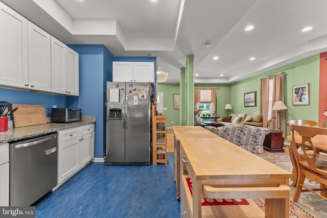5012 Catalpha Rd, Baltimore, MD 21214 - kitchen featuring appliances with stainless steel finishes, butcher block countertops, white cabinetry, recessed lighting, and open floor plan