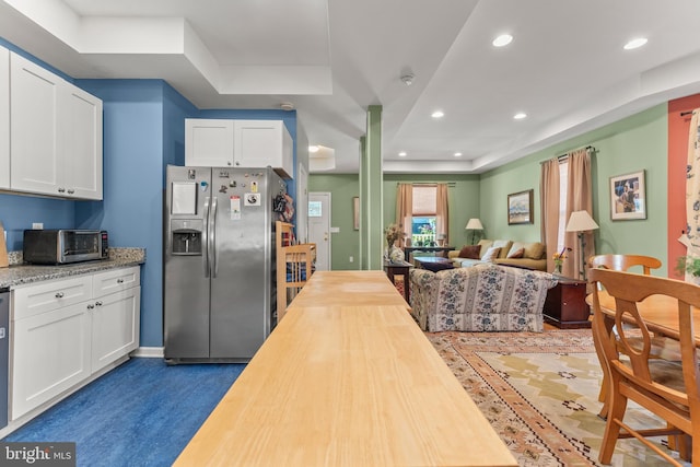 5012 Catalpha Rd, Baltimore, MD 21214 - kitchen with stainless steel fridge with ice dispenser, wood counters, white cabinets, open floor plan, and recessed lighting