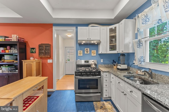 5012 Catalpha Rd, Baltimore, MD 21214 - kitchen with appliances with stainless steel finishes, under cabinet range hood, white cabinets, and glass insert cabinets