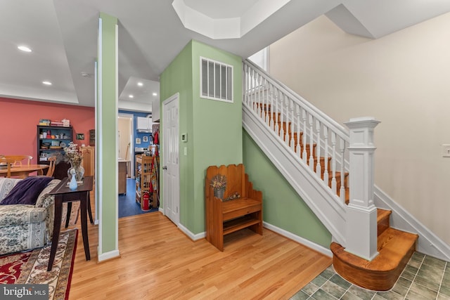 5012 Catalpha Rd, Baltimore, MD 21214 - stairs featuring wood finished floors, recessed lighting, and a raised ceiling