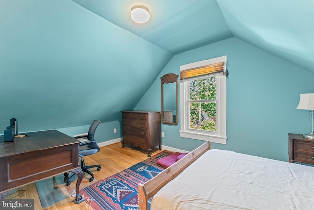 5012 Catalpha Rd, Baltimore, MD 21214 - bedroom with wood finished floors, vaulted ceiling, and a desk