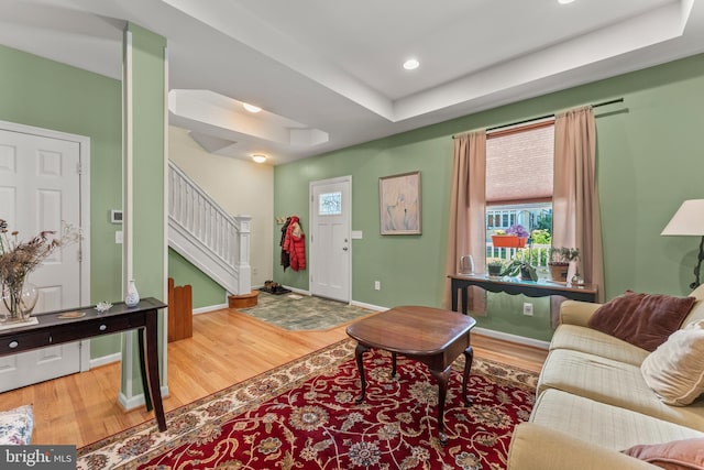 5012 Catalpha Rd, Baltimore, MD 21214 - living room with wood finished floors, stairs, a tray ceiling, and recessed lighting