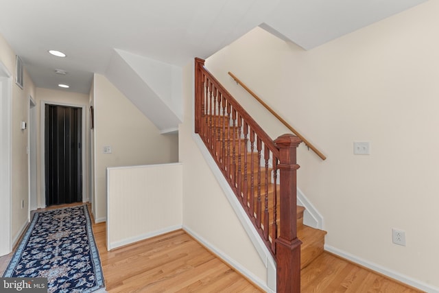 5012 Catalpha Rd, Baltimore, MD 21214 - stairway featuring wood finished floors and recessed lighting