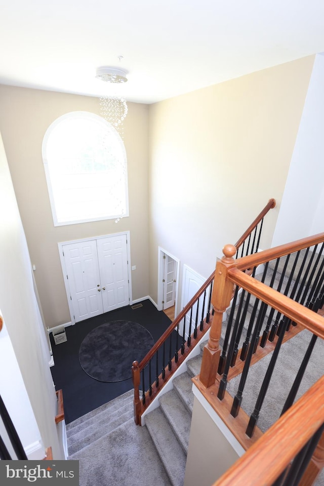 14714 Mount Calvert Rd, Upper Marlboro, MD 20772 - entryway with carpet floors, stairs, and a chandelier