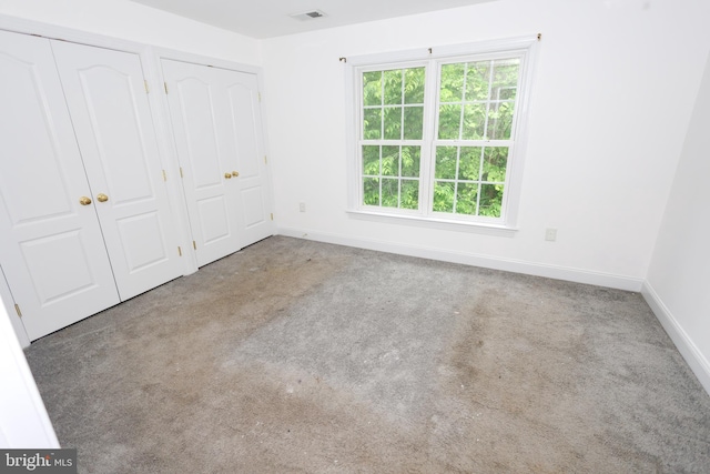 14714 Mount Calvert Rd, Upper Marlboro, MD 20772 - unfurnished bedroom with baseboards, multiple closets, and carpet flooring