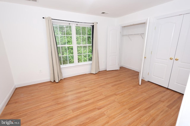 14714 Mount Calvert Rd, Upper Marlboro, MD 20772 - unfurnished bedroom featuring light wood finished floors, two closets, and baseboards