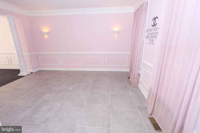 14714 Mount Calvert Rd, Upper Marlboro, MD 20772 - empty room with ornate columns, crown molding, a decorative wall, wainscoting, and light tile patterned floors